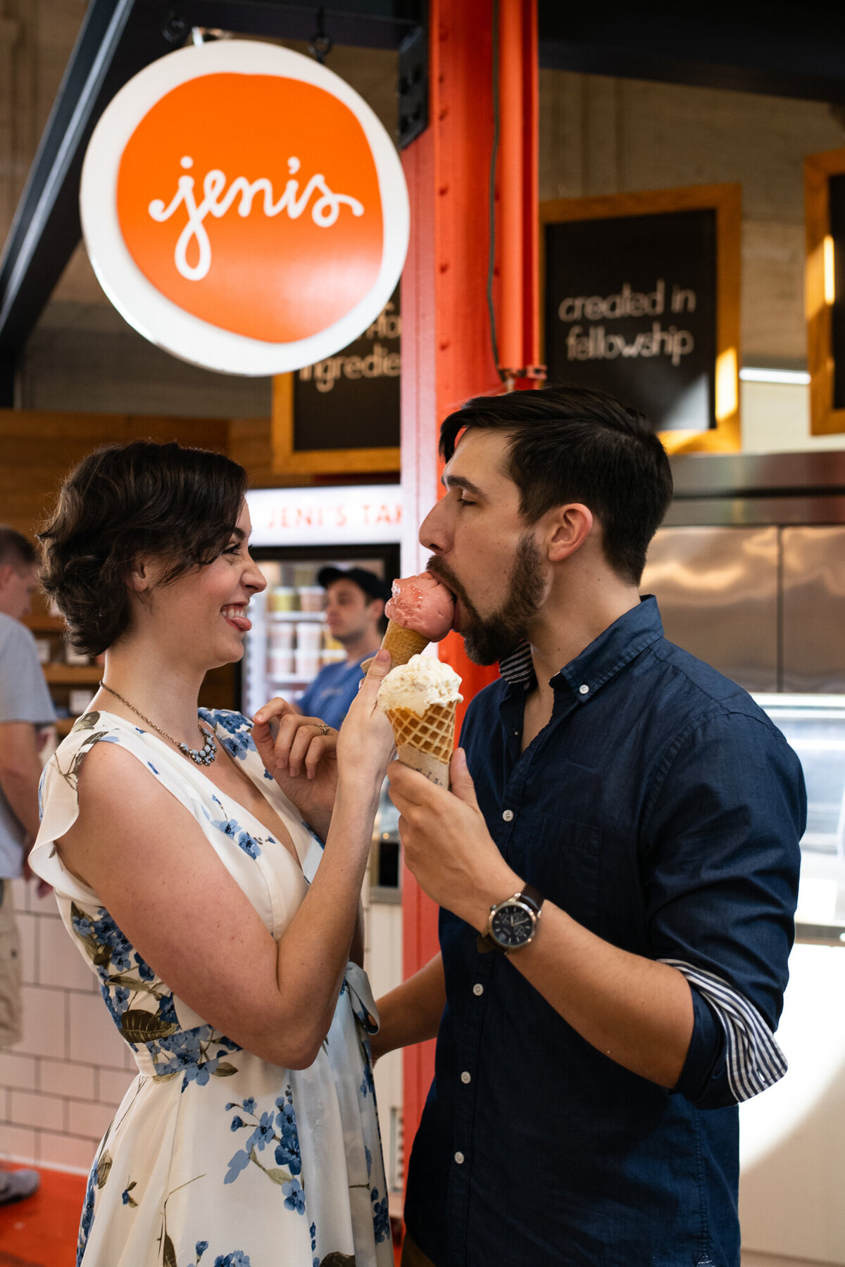Couple shares ice cream during engagement session at North Market