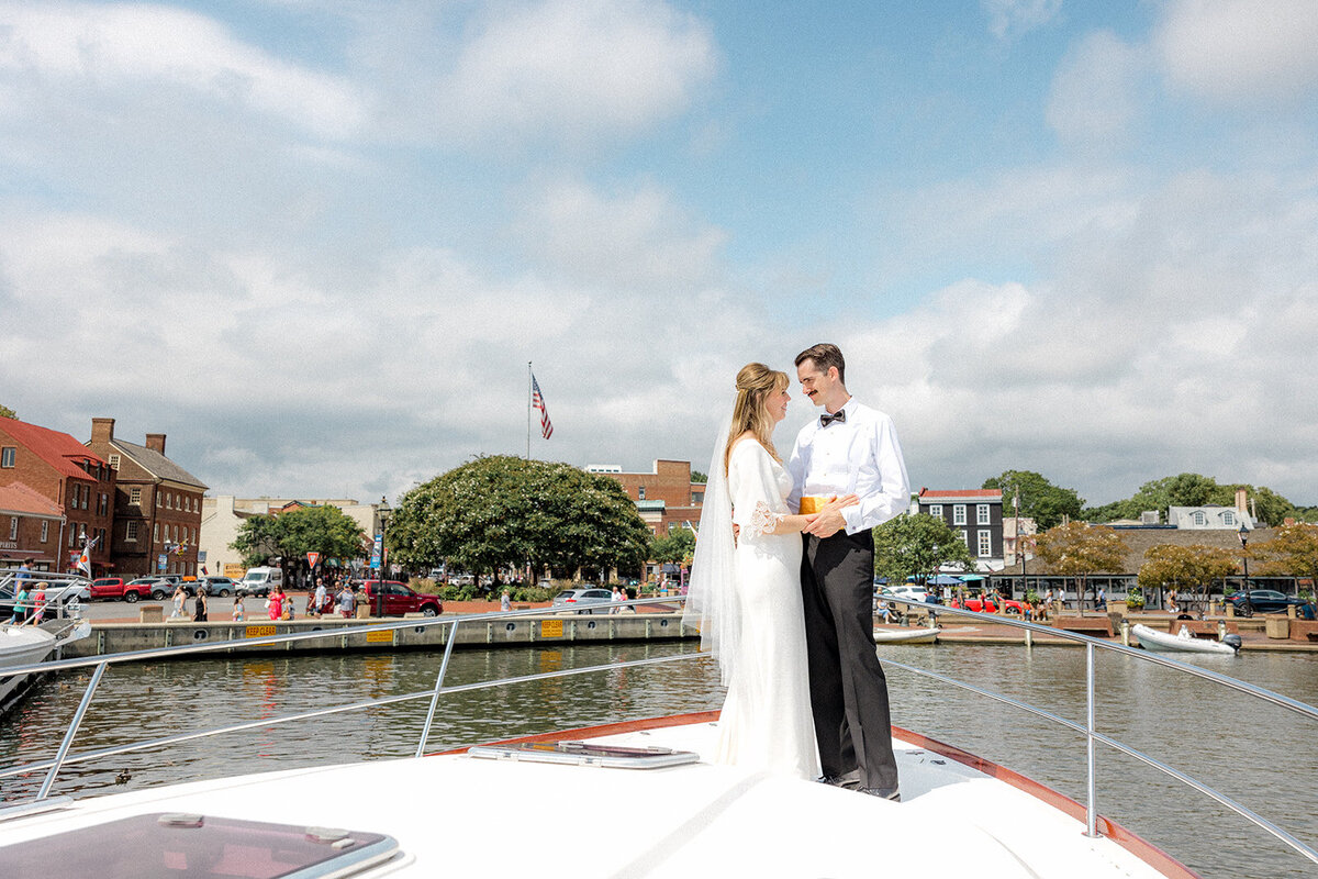 Bride and groom on boat looking into each other's eyes