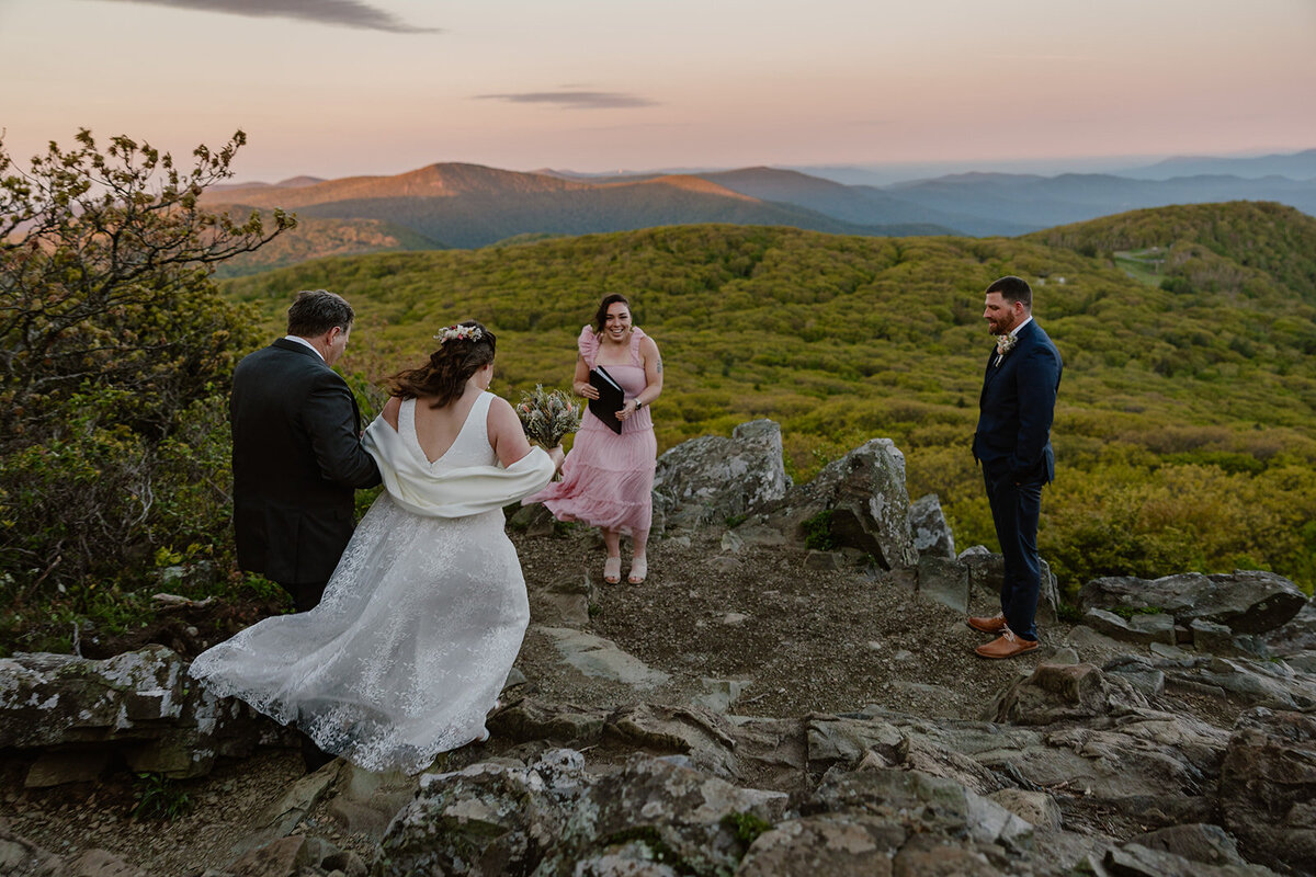 The father of the bride walks his daughter to meet her husband for their sunrise elopement ceremony at Stony Man Summit
