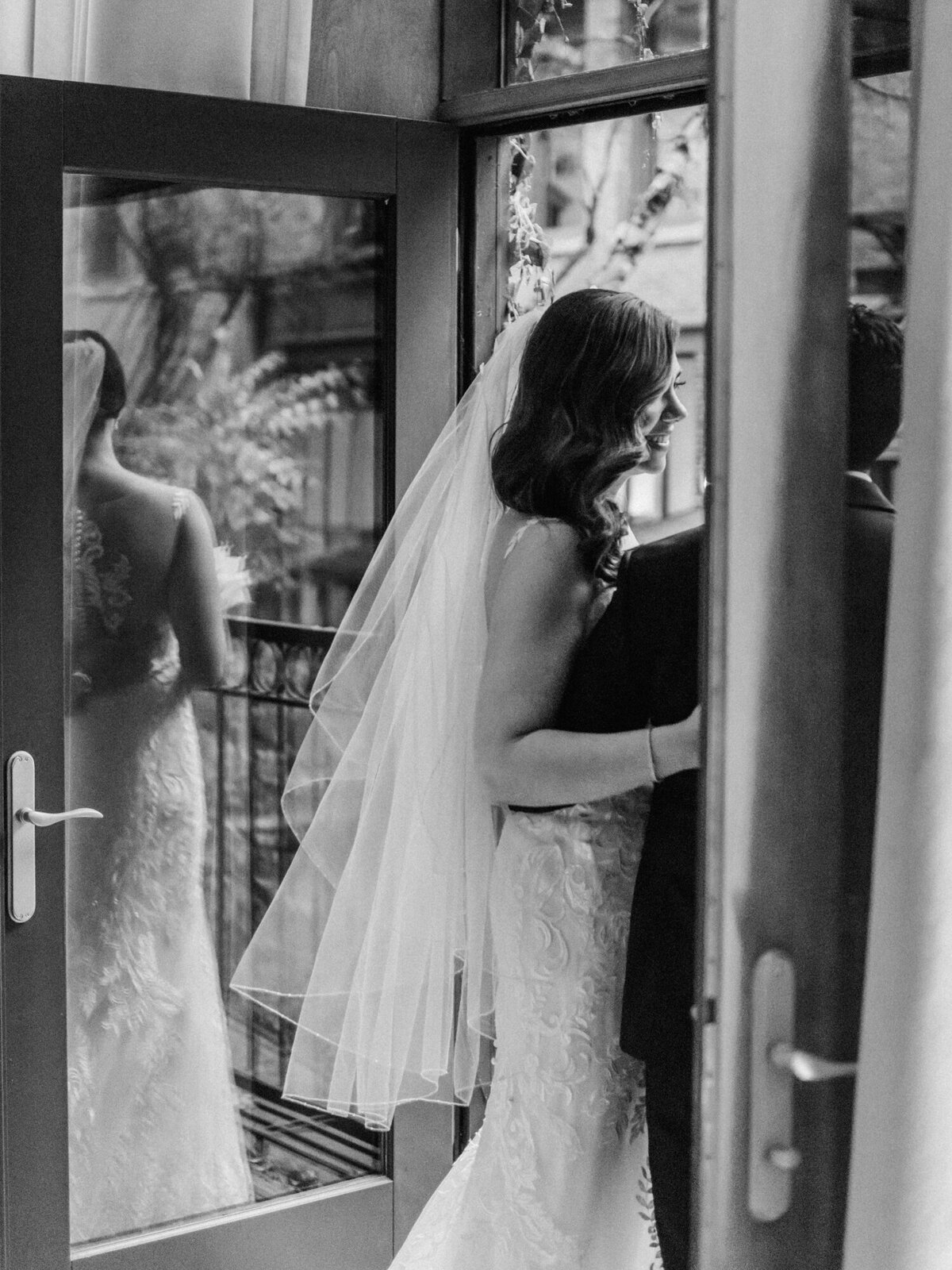 A couple pose on the Juliet Balcony at the Ivy Room in Chicago