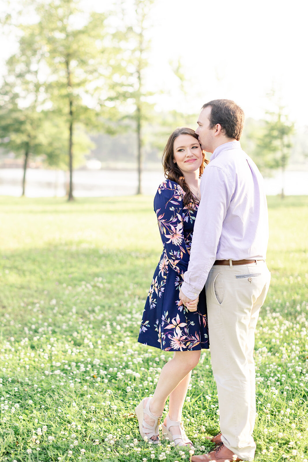 Engagement photo of guy kissing girl on forehead