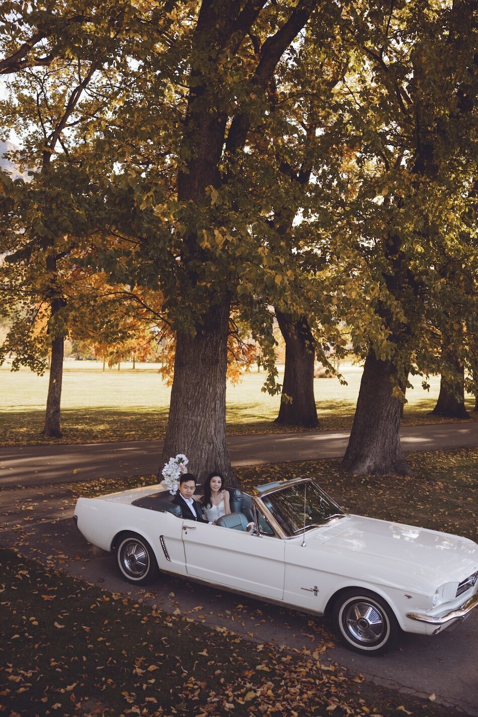 Autumn wedding shoot at Millbrook, Arrowtown. Vintage car & helicopter.