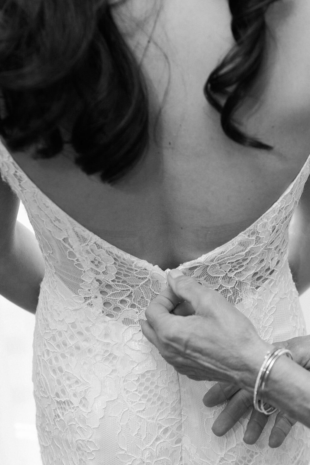 Mom zipping up gown