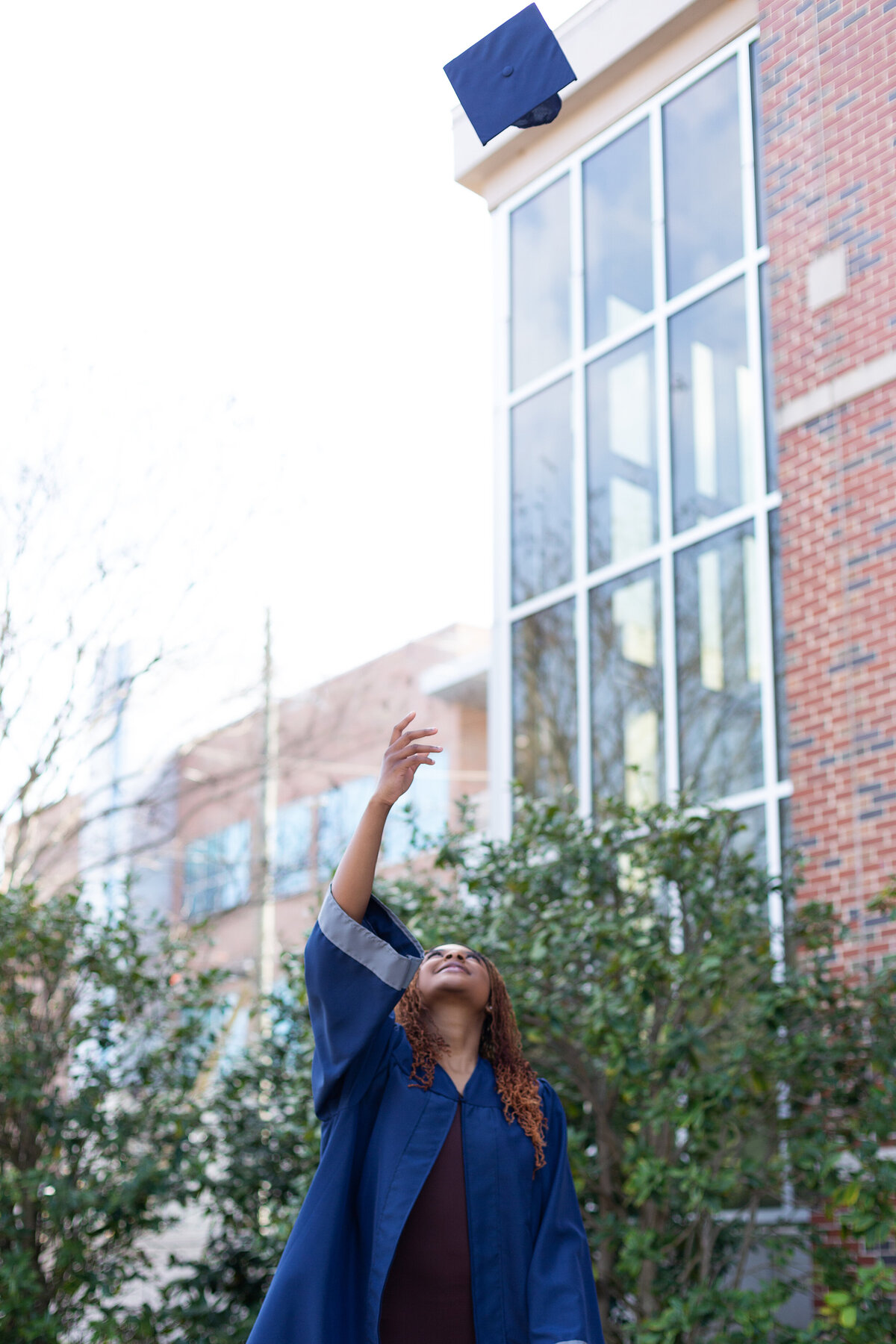 Destiny tosses her graduation cap for her outdoor senior session.