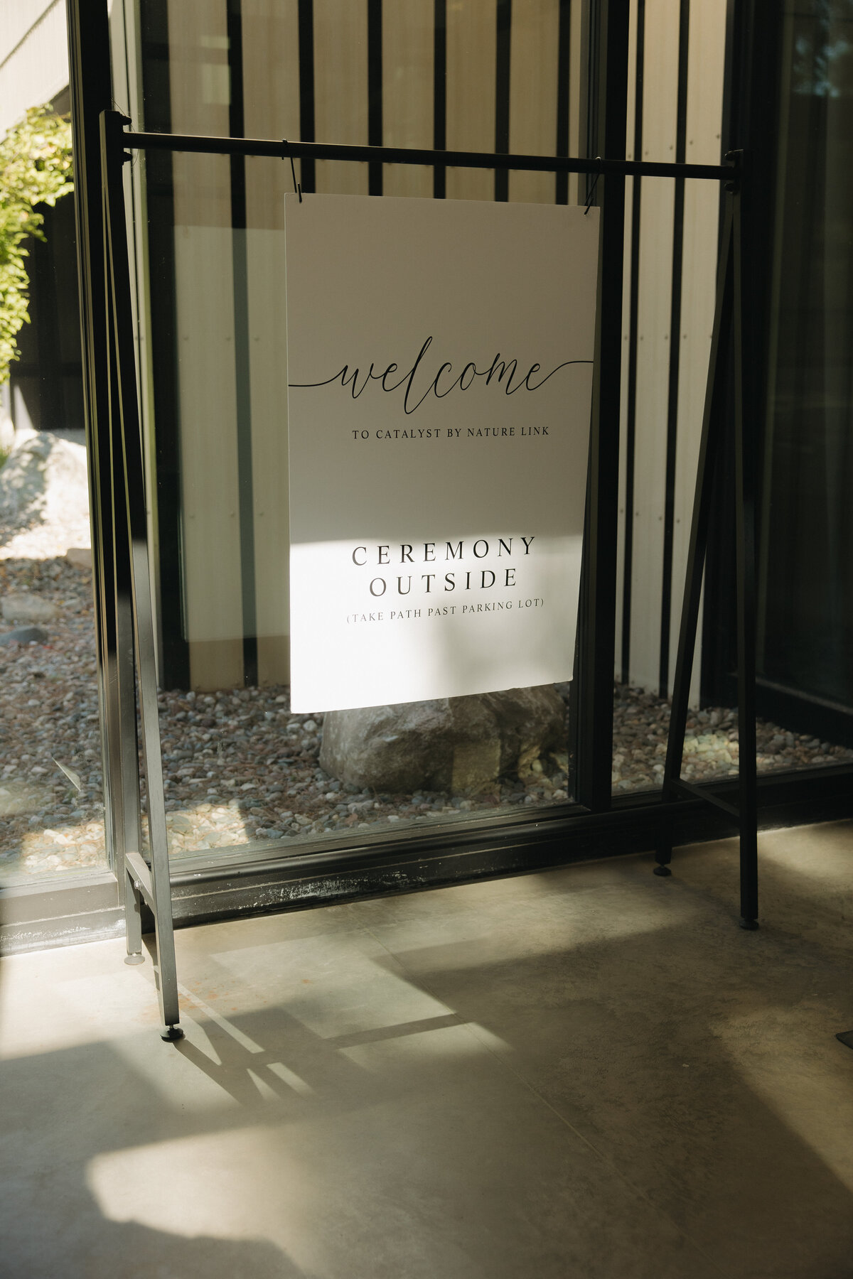 Wedding welcome sign with instructions on how to get to ceremony in the entry way of Catalyst by Nature Link