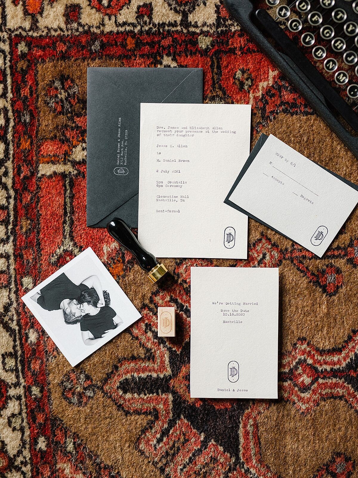 A handmade wedding stationery suite typed on an antique typewriter by the groom, stamped and sealed by the bride before being mailed off to each wedding guest are laid out on an oriental carpet.