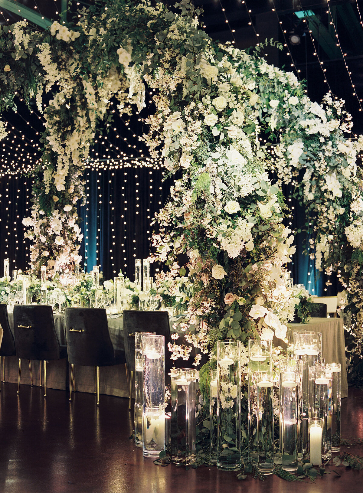 An Enchanting Wedding Setting with Lush Florals and Candlelit Elegance.