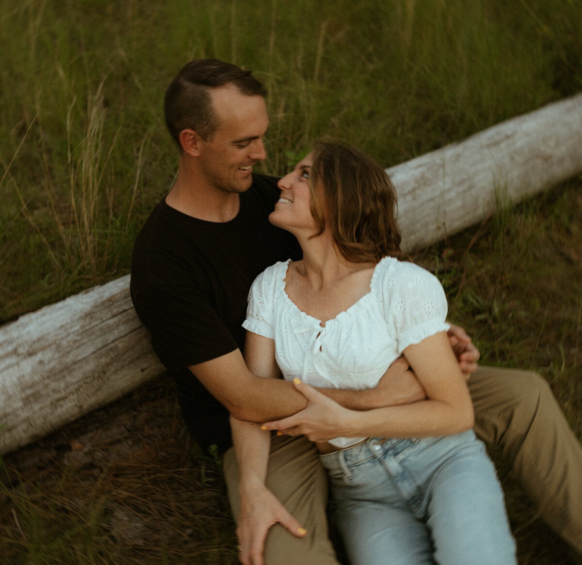Couple posing for portraits in a forest.