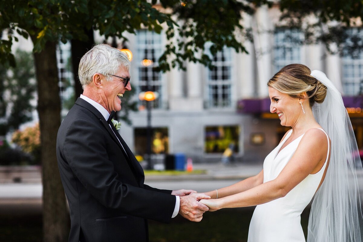 A bride and her dad share a first look before a Chicago Illumintaing Company wedding.