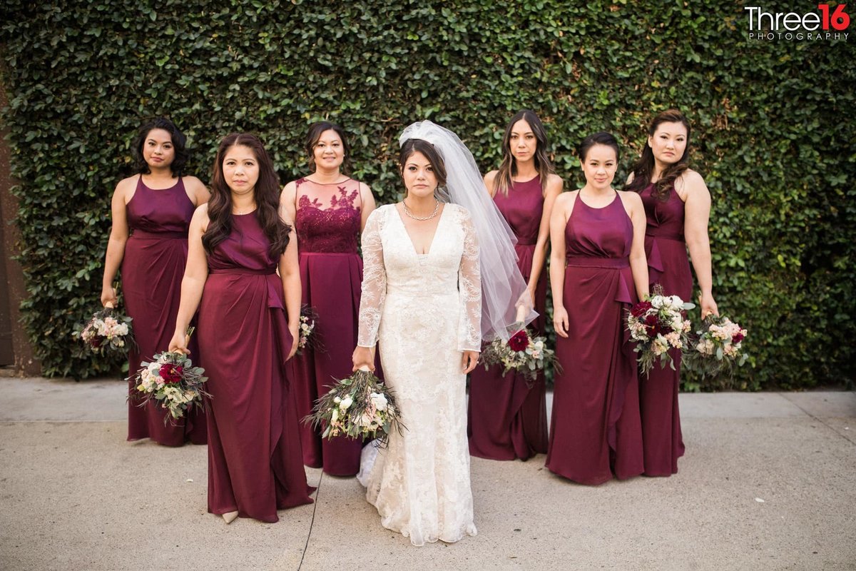 Bride and Bridesmaids pose with serious looks on their faces