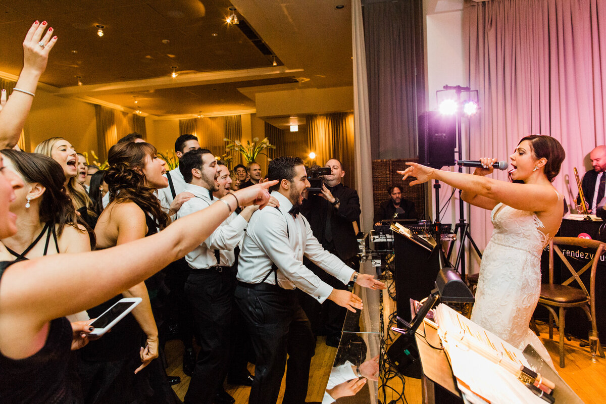 An electric moment during a wedding reception at the Ivy Room in Chicago when the bride joined the band and sang to her husband, friends and family
