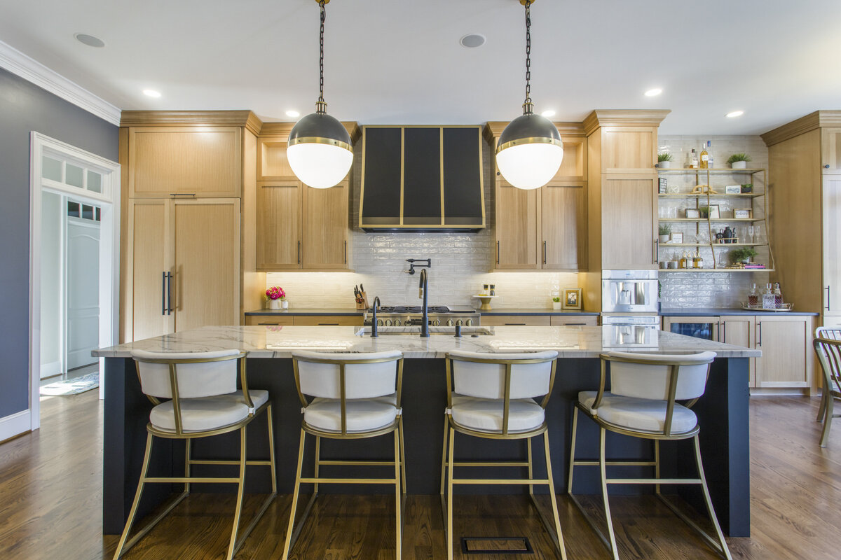 light wood kitchen with dark accents in the island and gold finishes