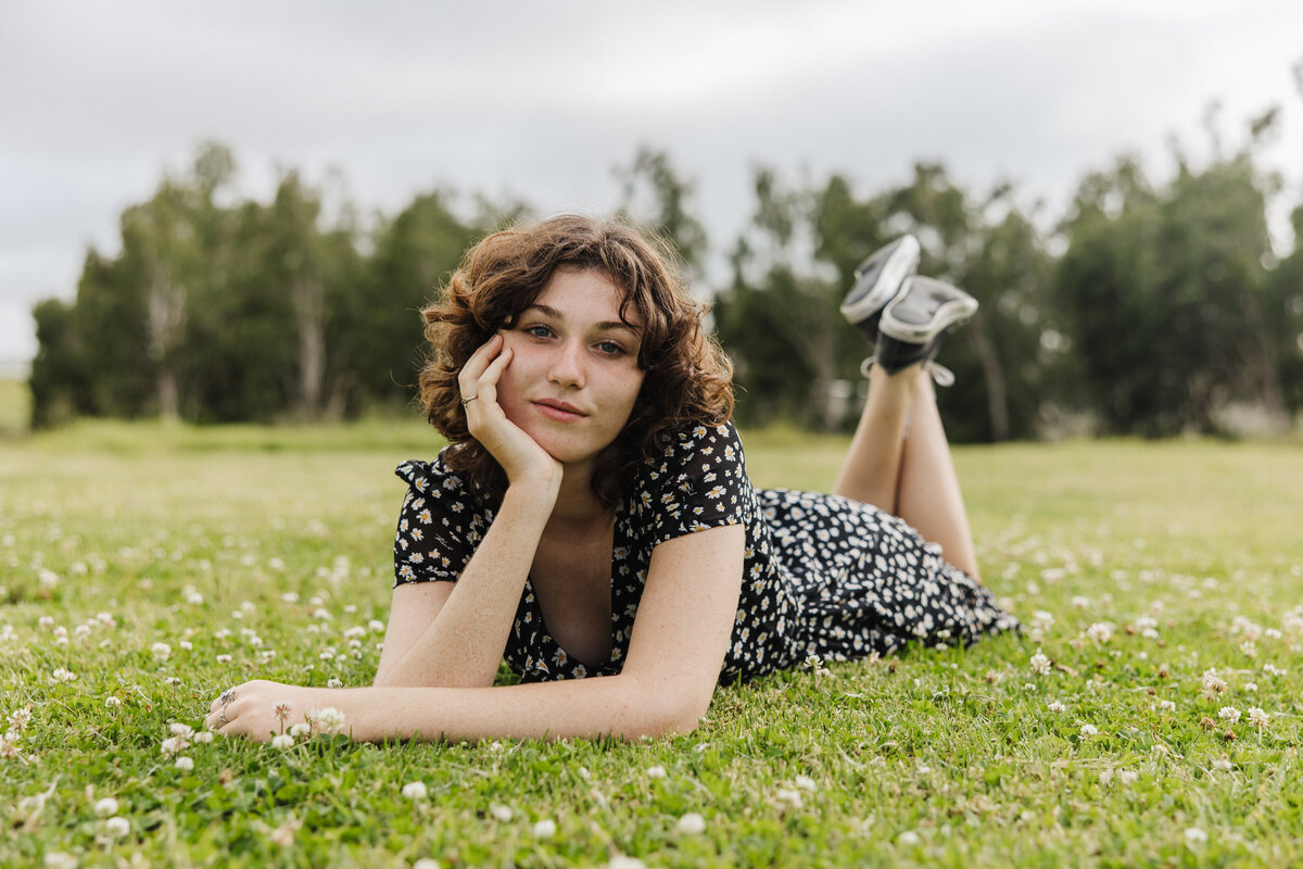 senior laying in grass