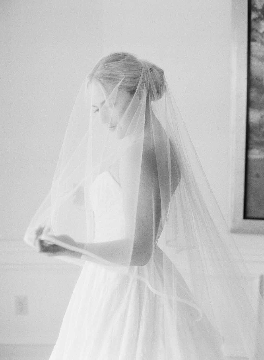 black and white photo of bride in long vail