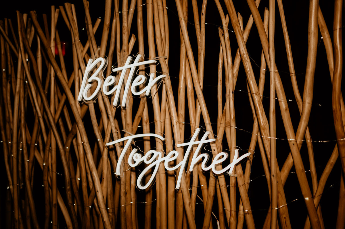 Little Rock wedding photographer photographs wedding decor of a neon sign that reads "better together"
