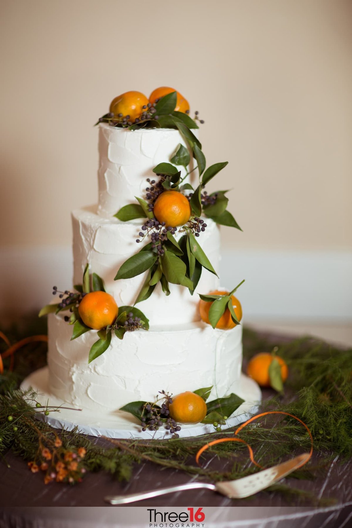 Beautiful wedding cake with oranges on it