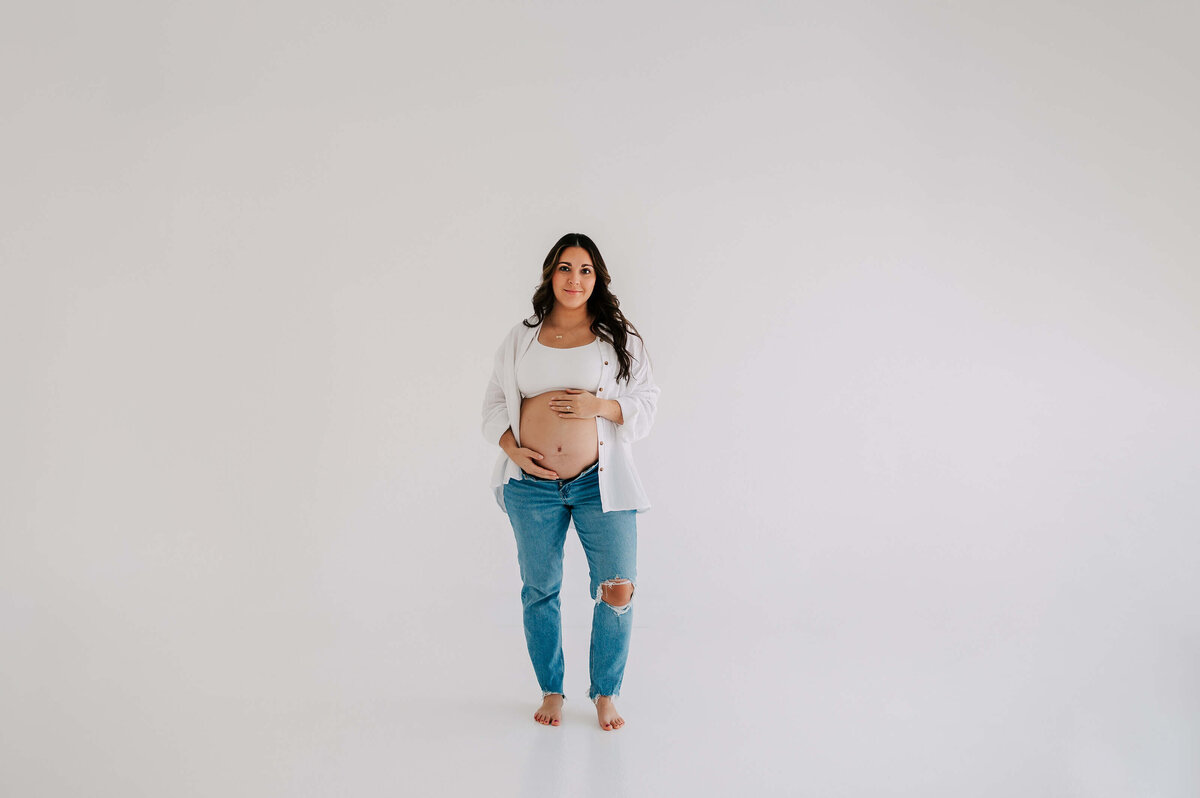 pregnant mom in jeans  during Joplin Mo maternity photography session