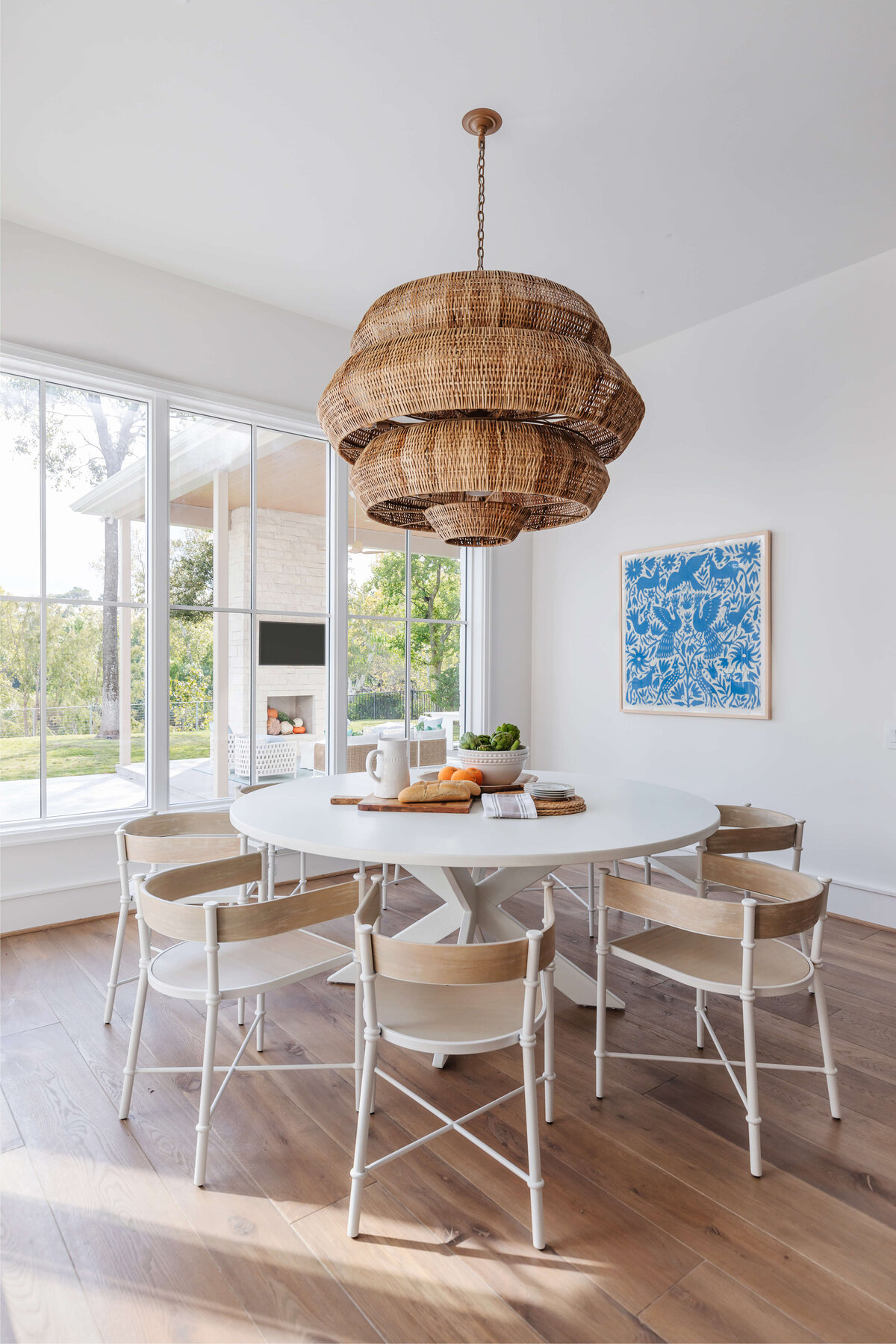 oyster creek studios memorial new build wicker light with wooden chairs around white kitchen table