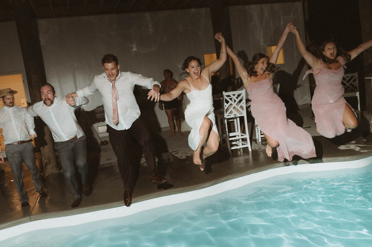 Wedding party jumps in pool fully clothed at the end of the night