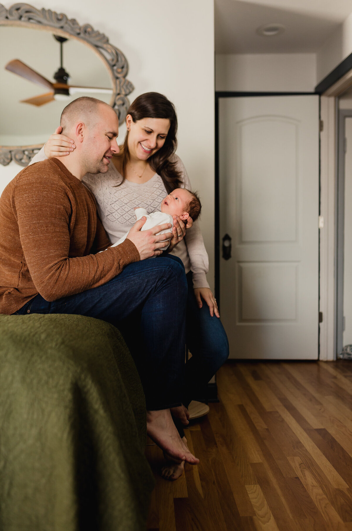Family Photoshoot Session with mom, and dad holding newborn baby.