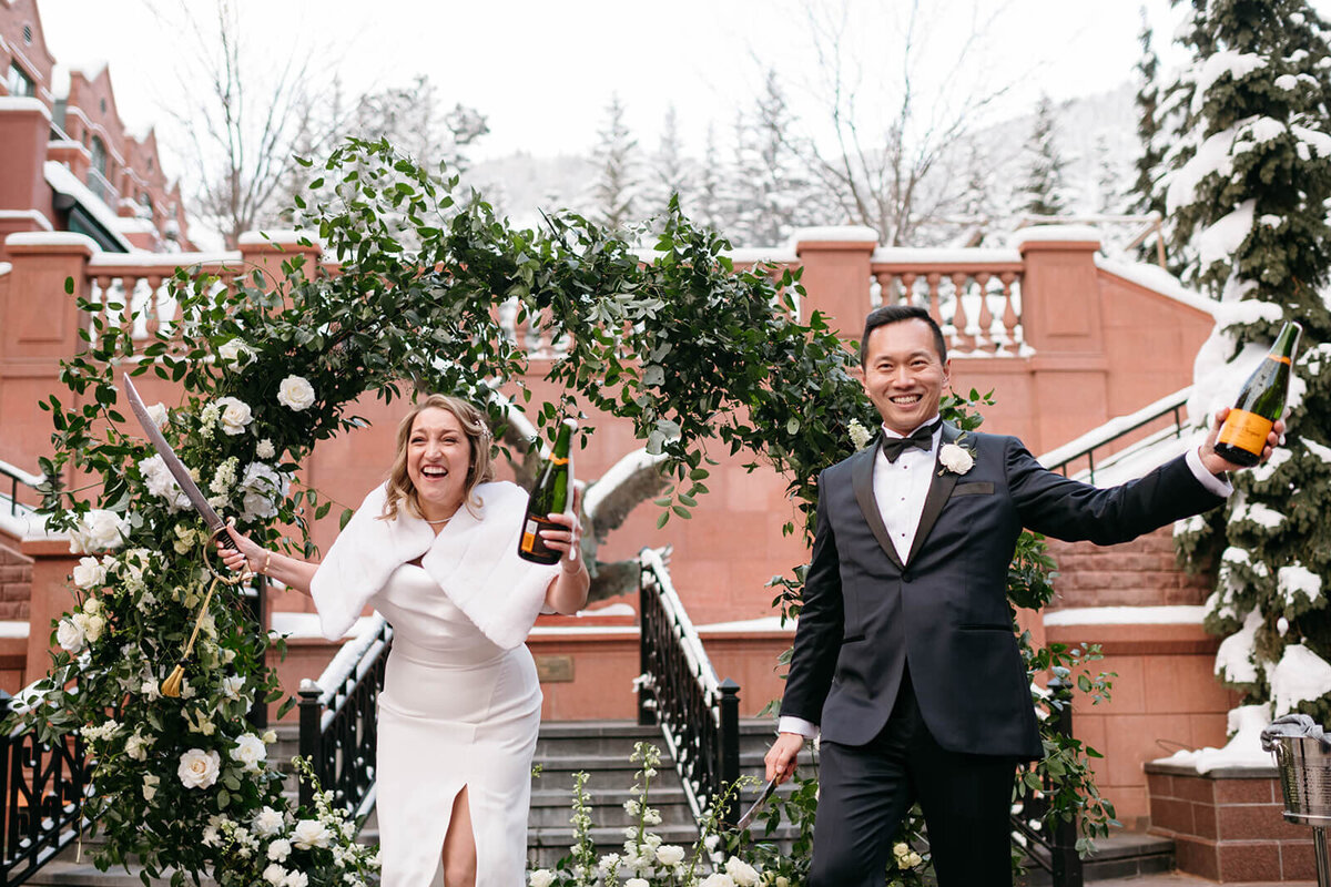 Bride and Groom at St. Regis Aspen Wedding celebrate their marriage with champagne.