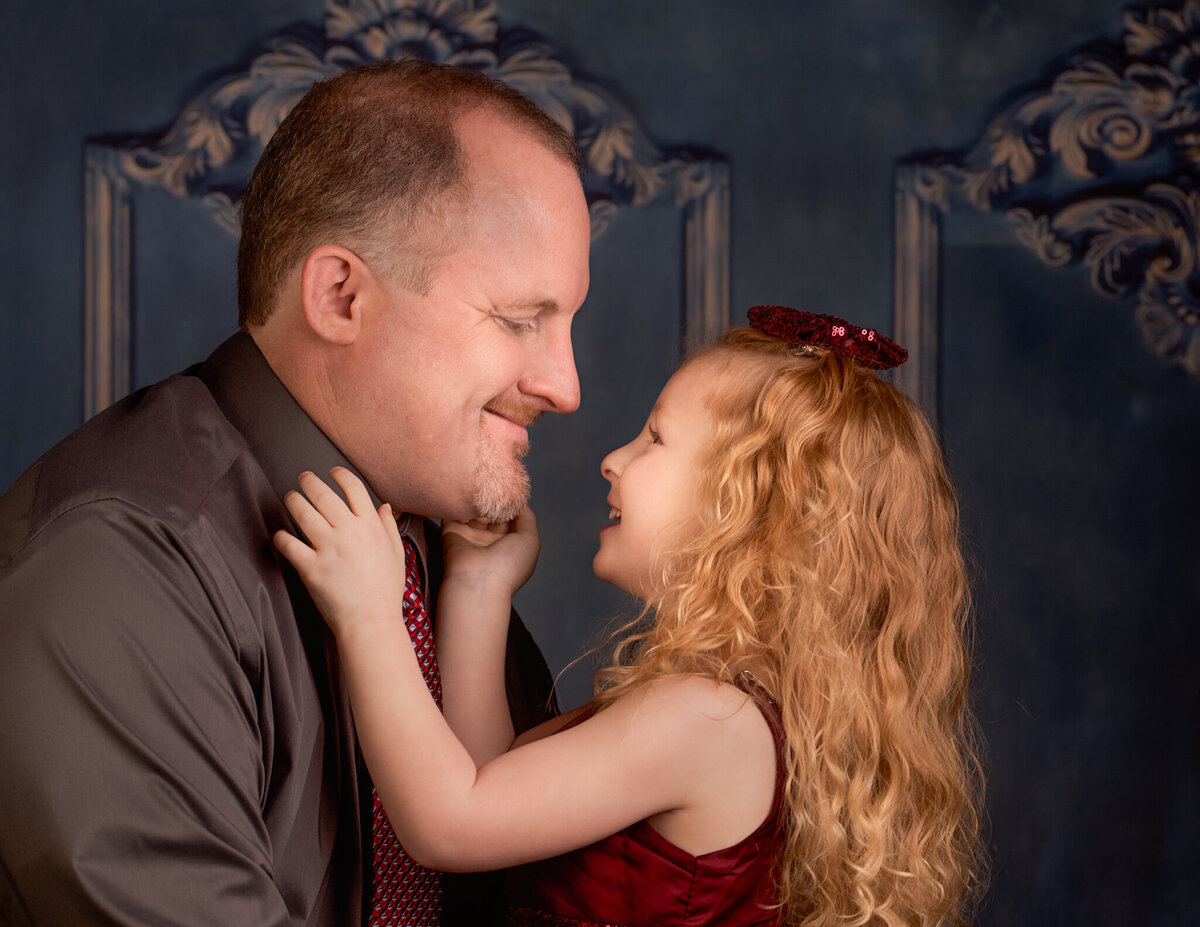 Heartwarming close-up portrait of a father and daughter sharing a tender moment, captured in Prairie Village, Kansas. A meaningful option for families wanting emotional and intimate family photography.