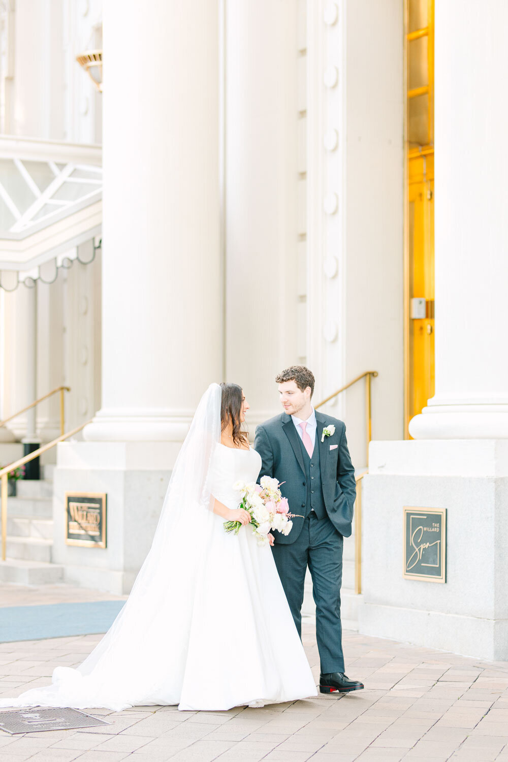 Couple walking outside hotel entrance