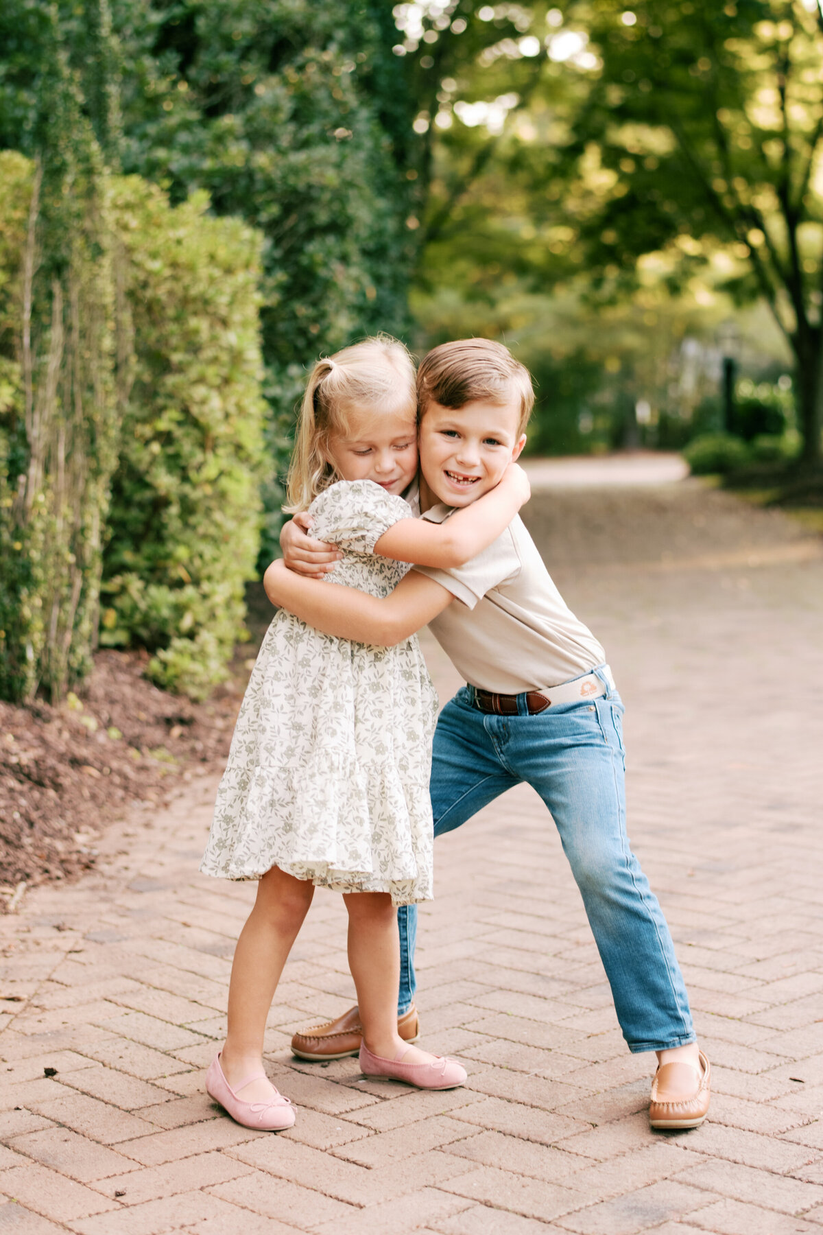 Siblings hug and play. Image by Raleigh maternity photographer A.J. Dunlap Photography.