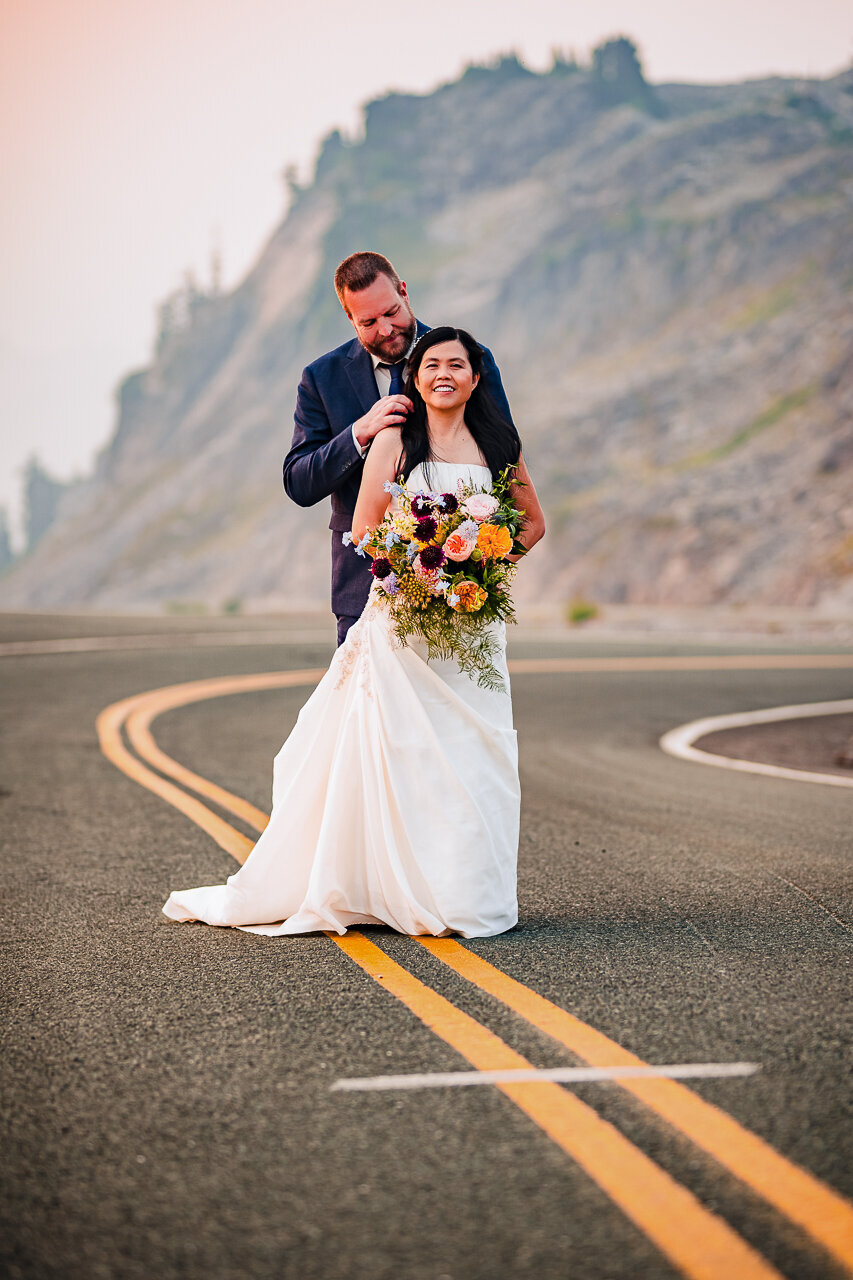 bride-and-groom-middle-of-the-highway-mountain-backdrop