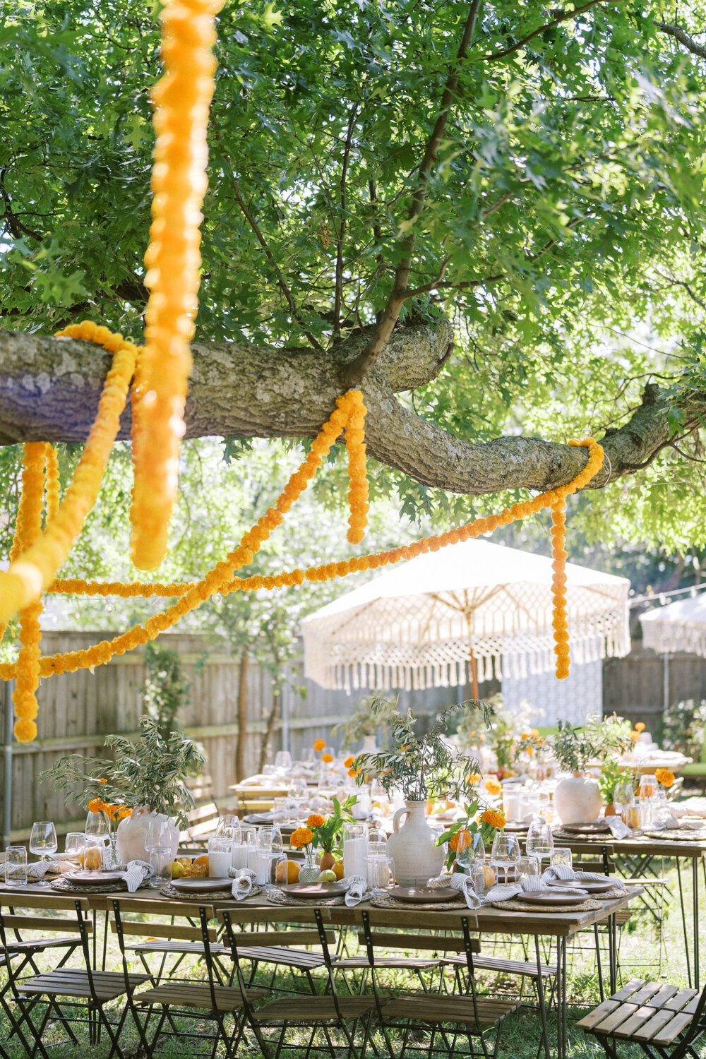 marigold-garland-strung-over-whimsical-backyard-wedding-tables