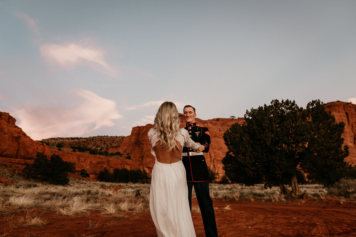 bride and groom spinning in the New Mexico desert