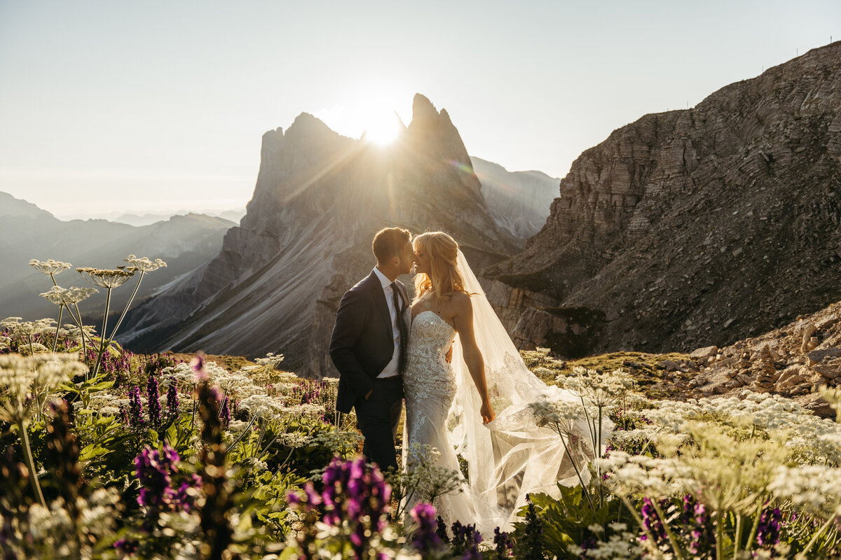 Wildflowers in foreground with bride and groom in distance