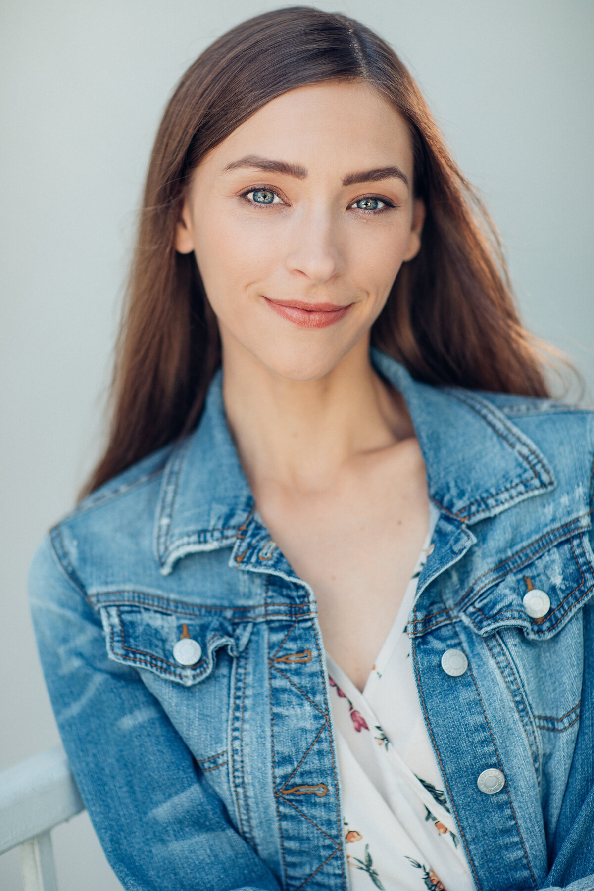 Headshot Photograph Of Young Woman In Outer Faded Blue Denim Jacket And Inner Floral Blouse Los Angeles