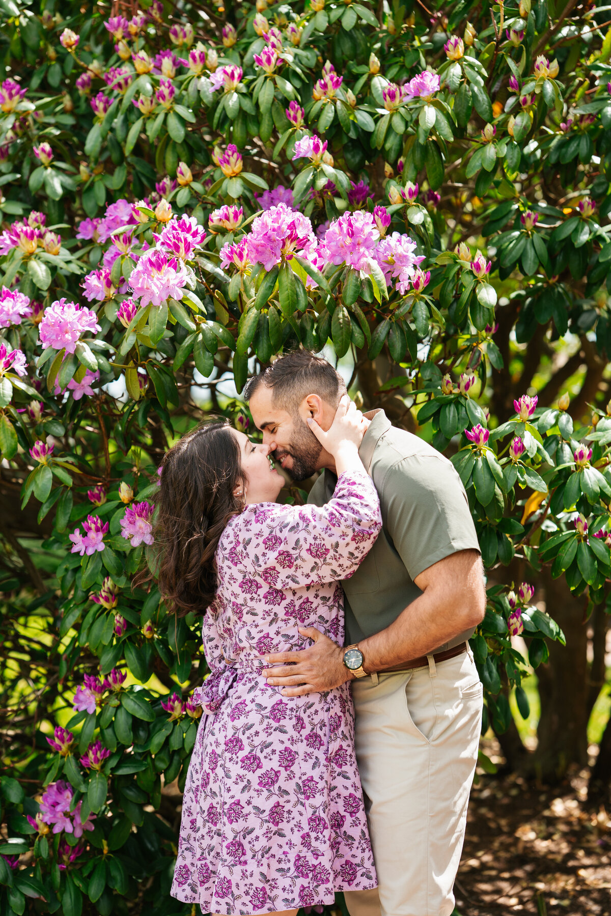 Couple walking through the rose garden at Lynch Park during their Beverly engagement session with Danielle Littles Photography