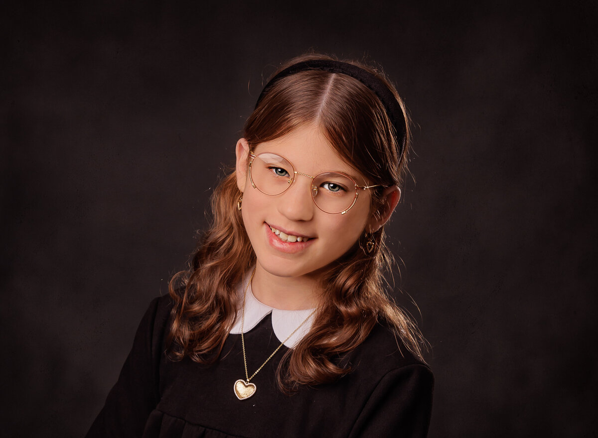 Young girl is captured for a studio portrait in brooklyn ny.  Captured by Brooklyn family photographer Chaya Bornstein