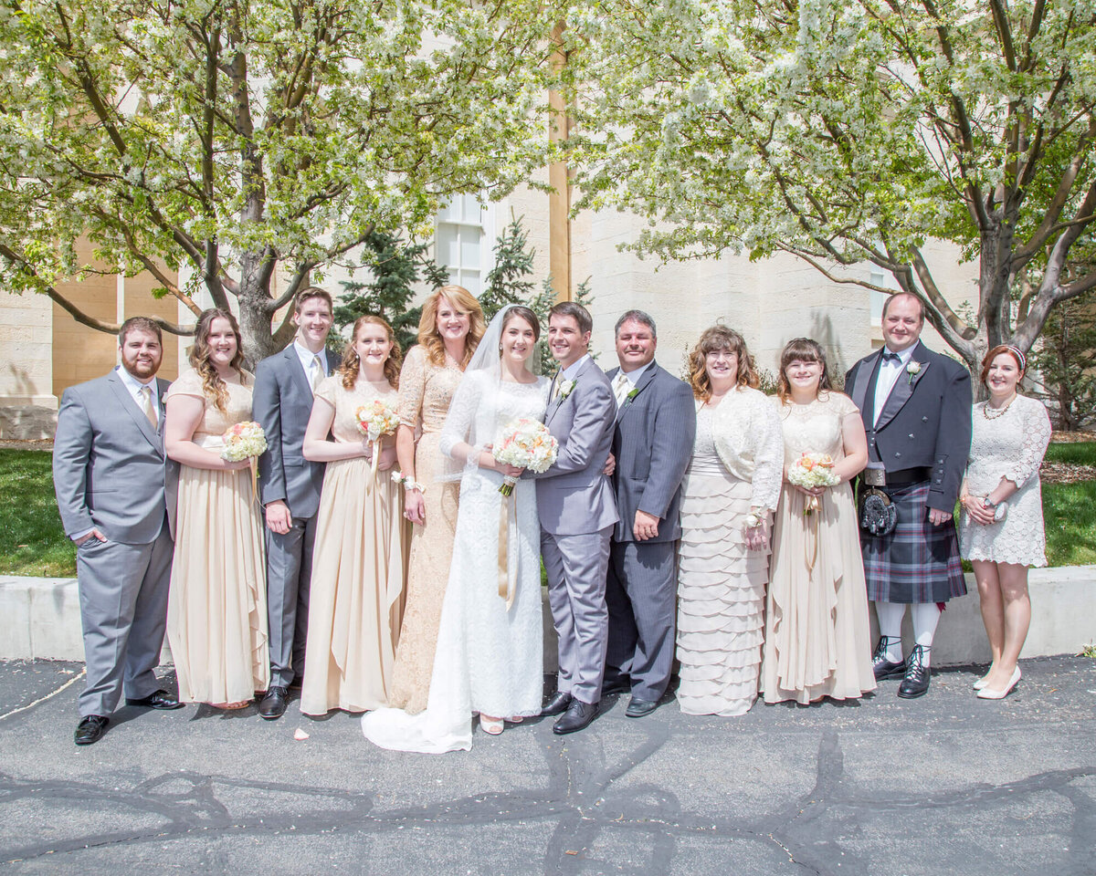 bride and groom with family in cream and gray at lds temple wedding