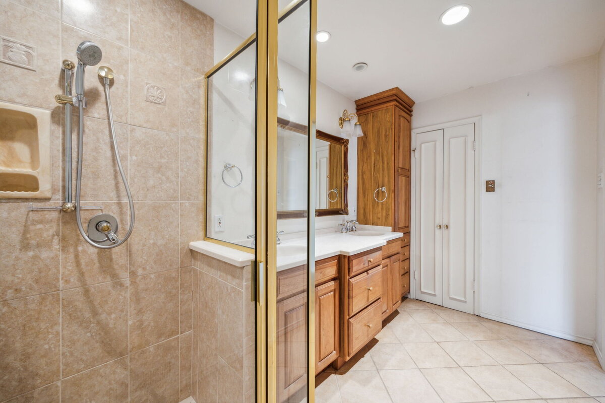14214_edgecrest_dr_dallas_tx_primary_bathroom_shower_view_-tile_walk_in_shower_dual_sink_vanity_and_storage-_haven_realty_group