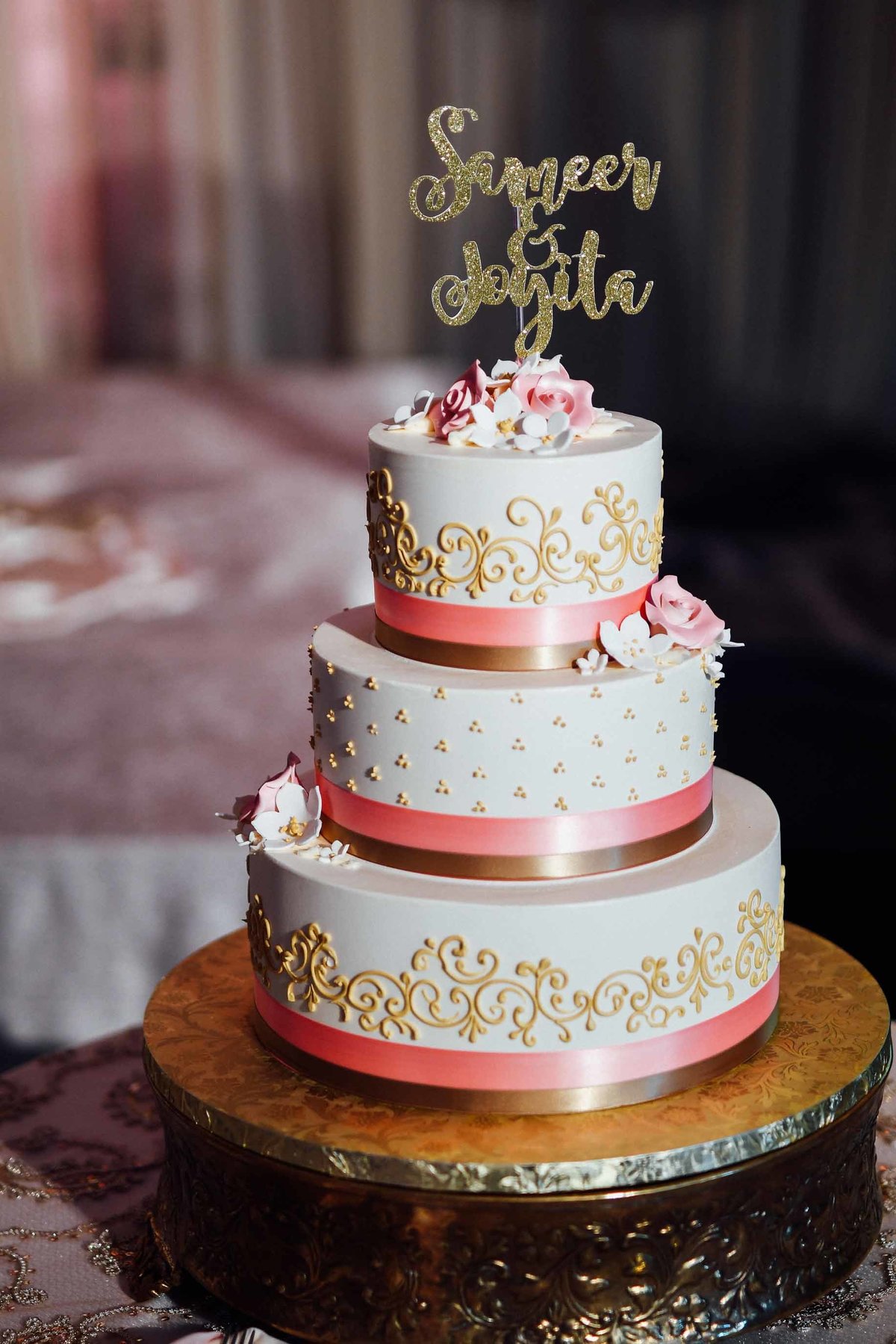 White layer cake with gold accents at summer Indian wedding