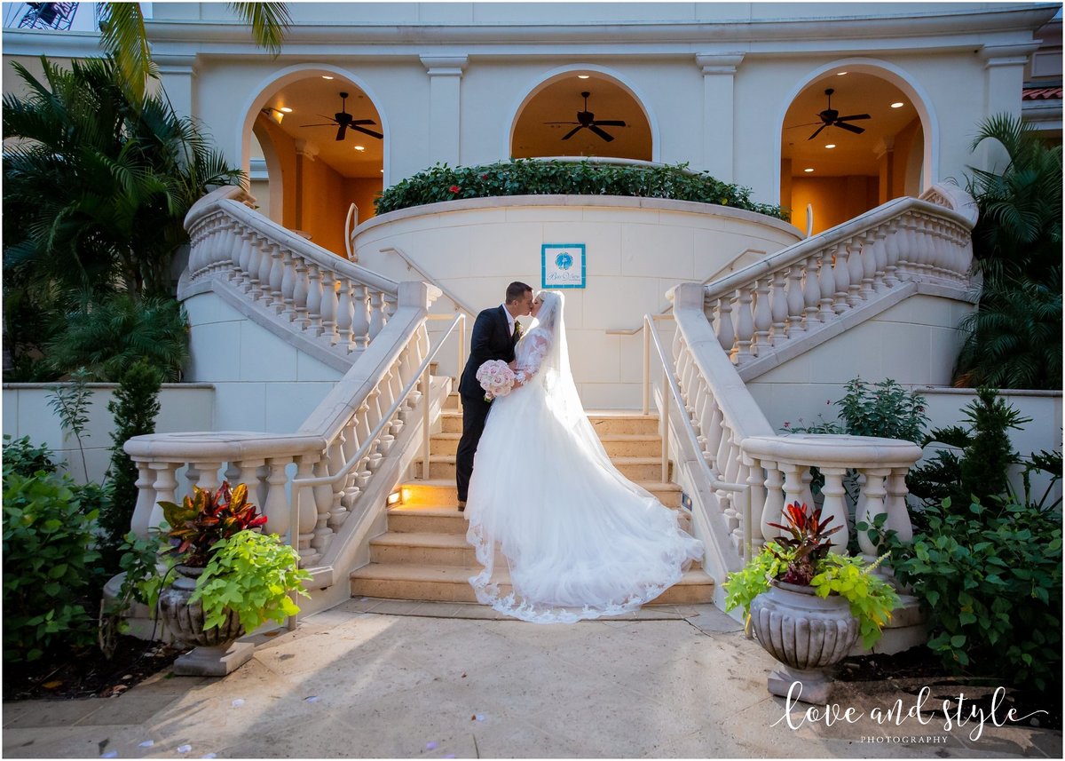 Bride and groom backlit on the staircase at The Ritz Carlton Sarasota