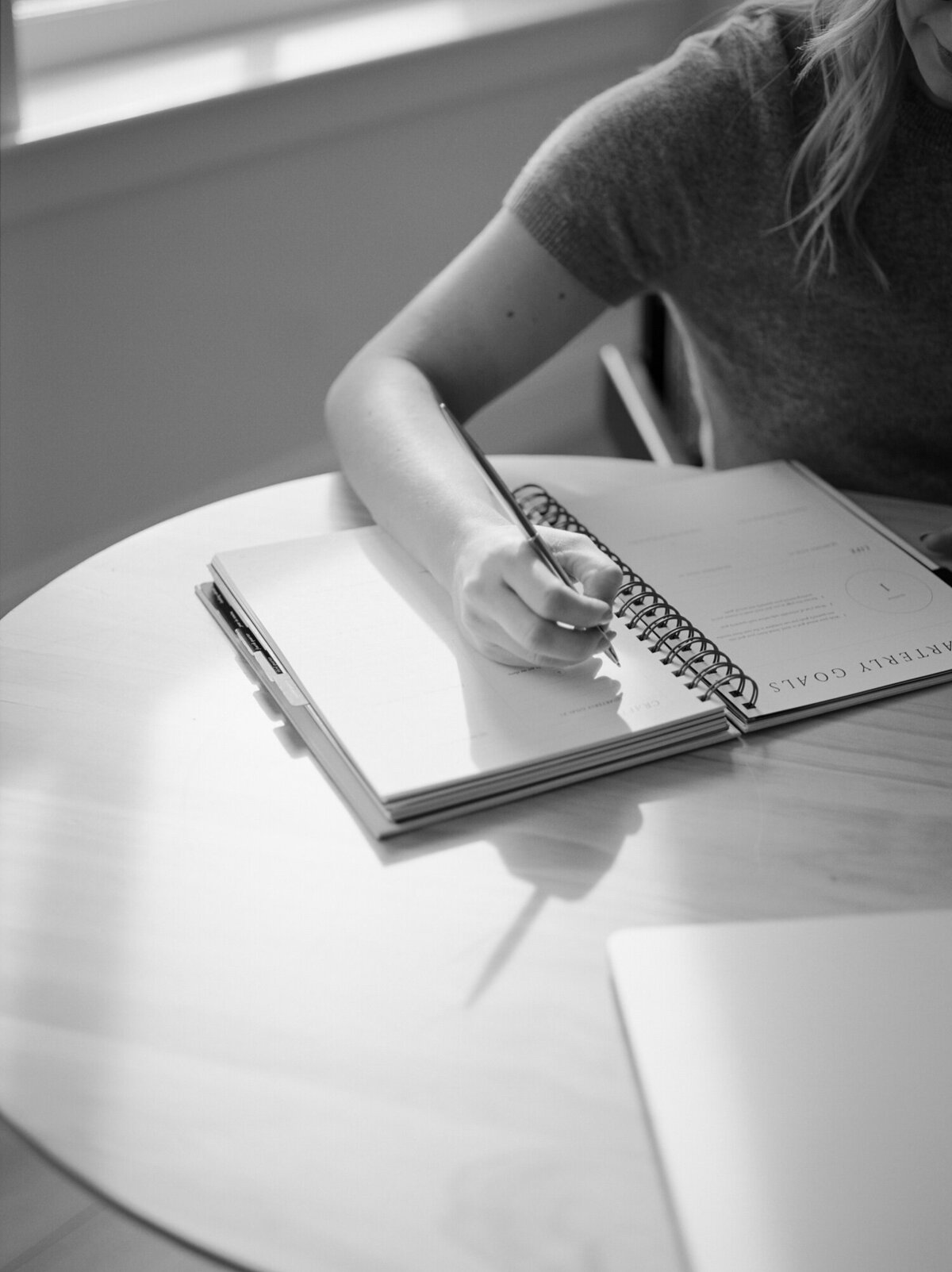 soft film branding photo, woman writing in journal, directional light and shadows