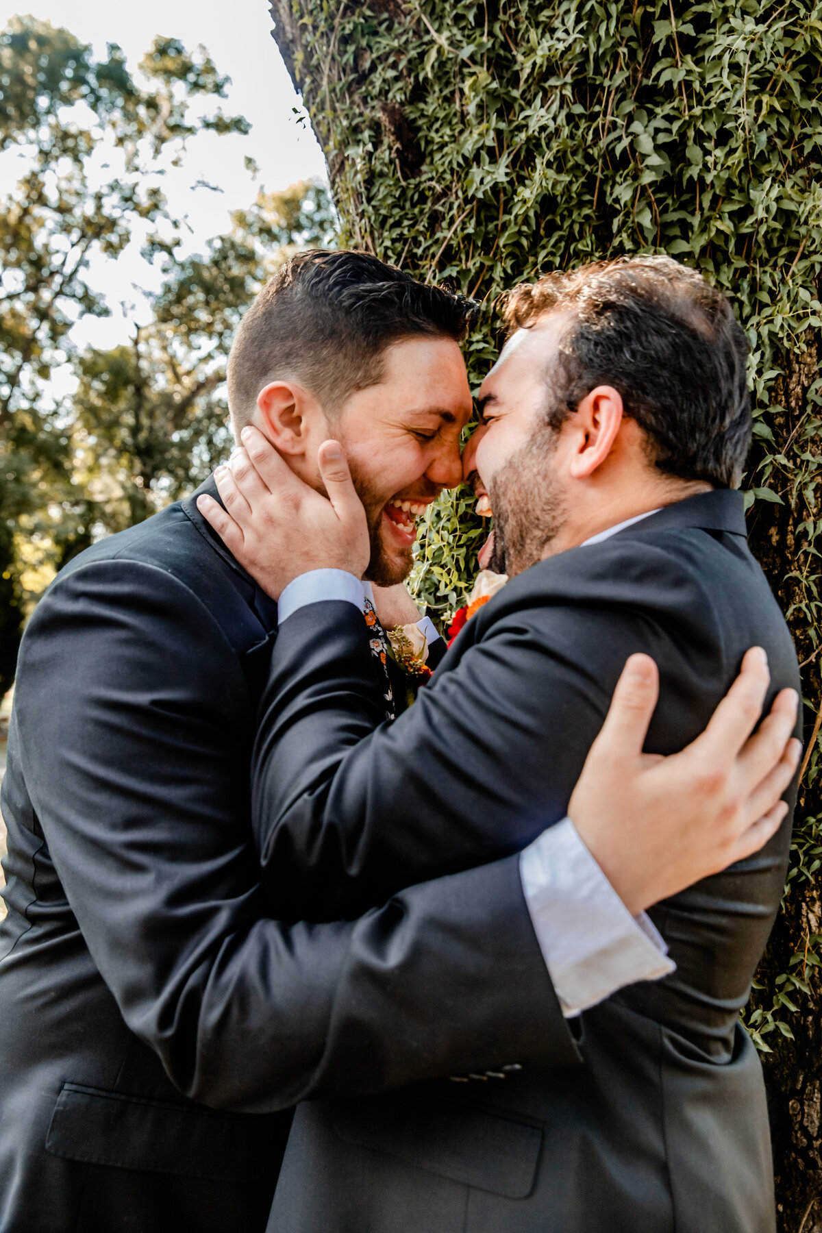 Shannon Lee, from Love Like Wild Photography, captures a joyful, intimate moment between two grooms sharing a loving embrace.