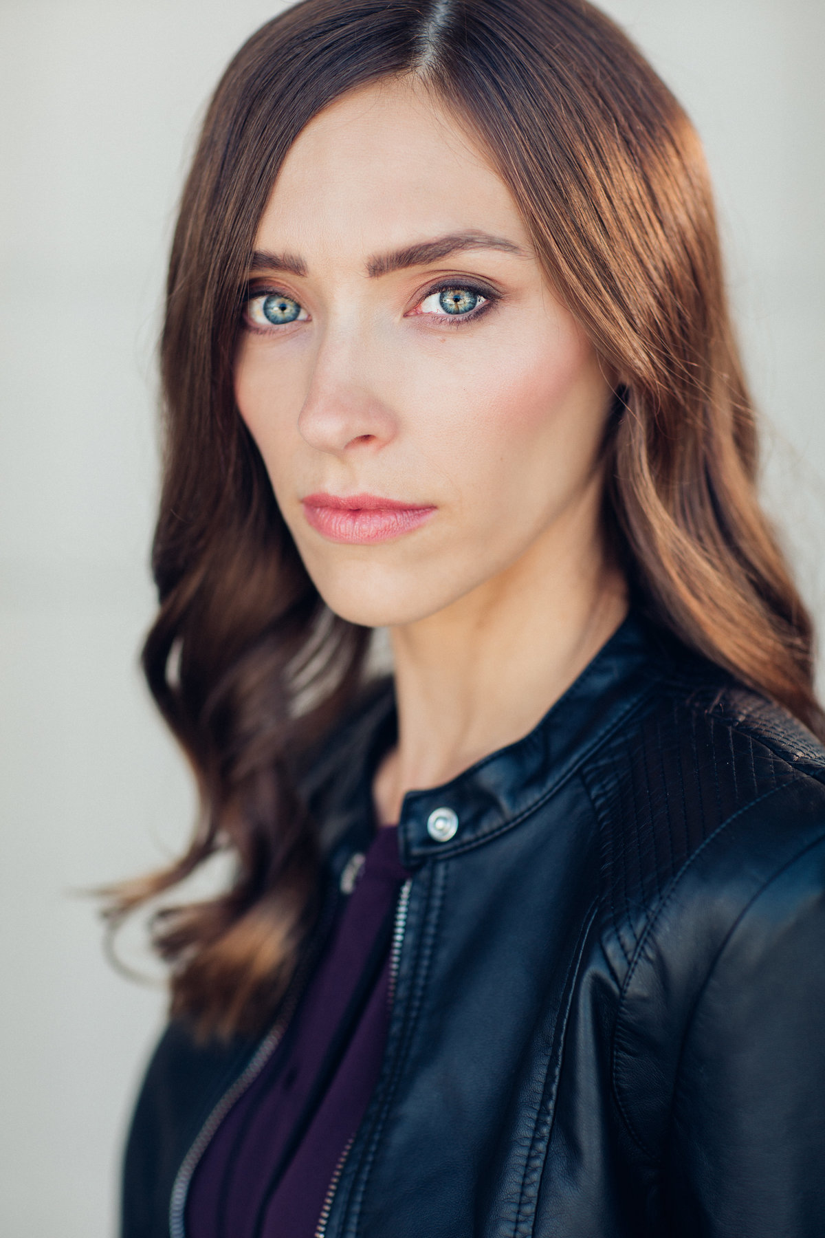 Headshot Photograph Of Young Woman In Outer Black Denim Jacket And Inner Violet Shirt Los Angeles