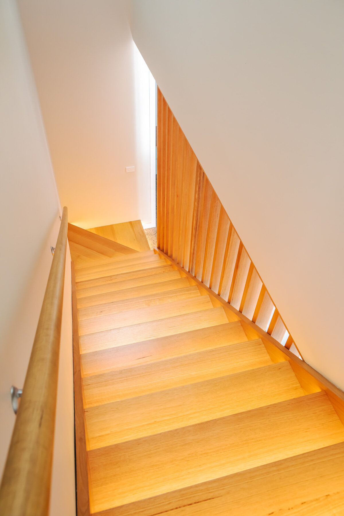 Sleek timber stairwell custom built by WBK building
