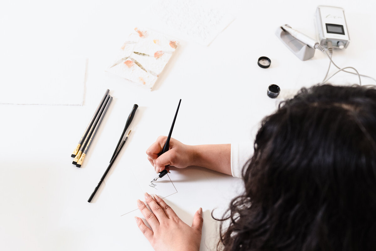 flat lay - calligrapher with her tools of the trade