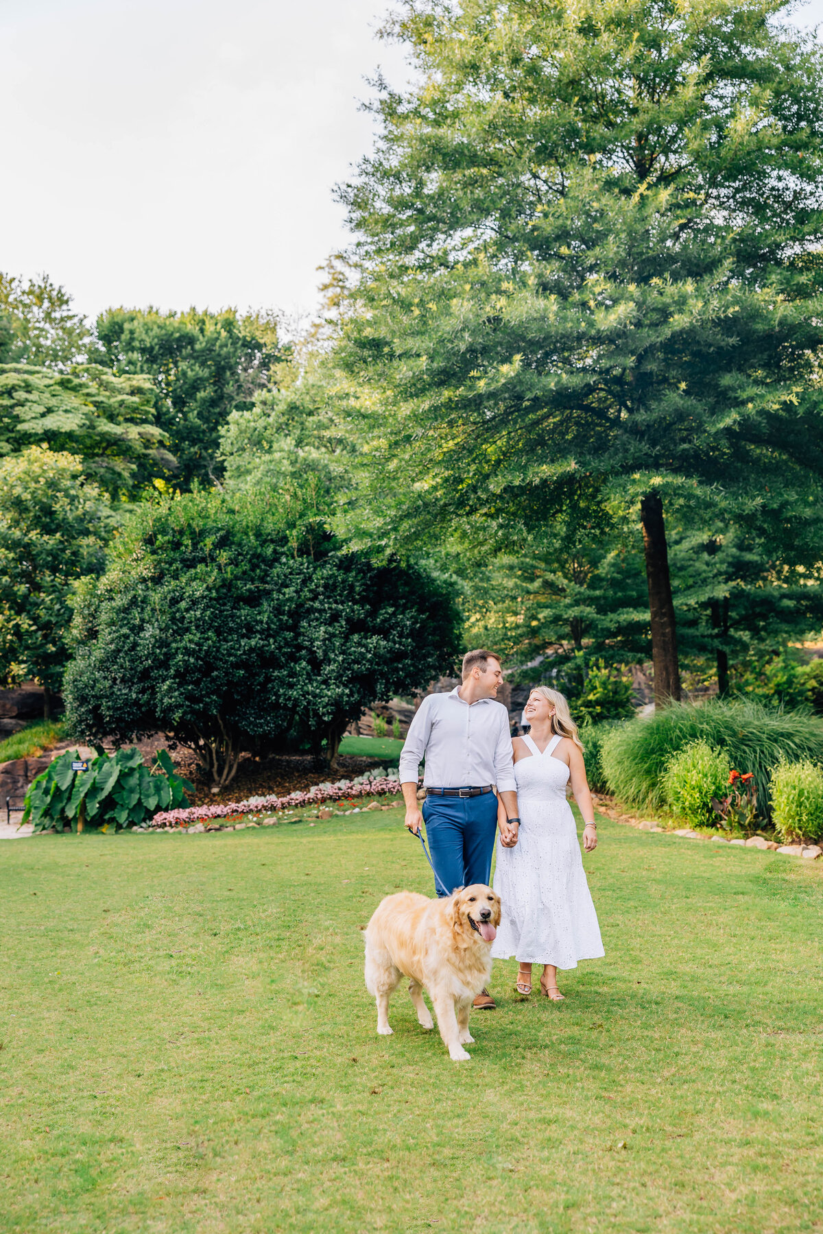 couple walking at park with golden retriever at south carolina rock quarry