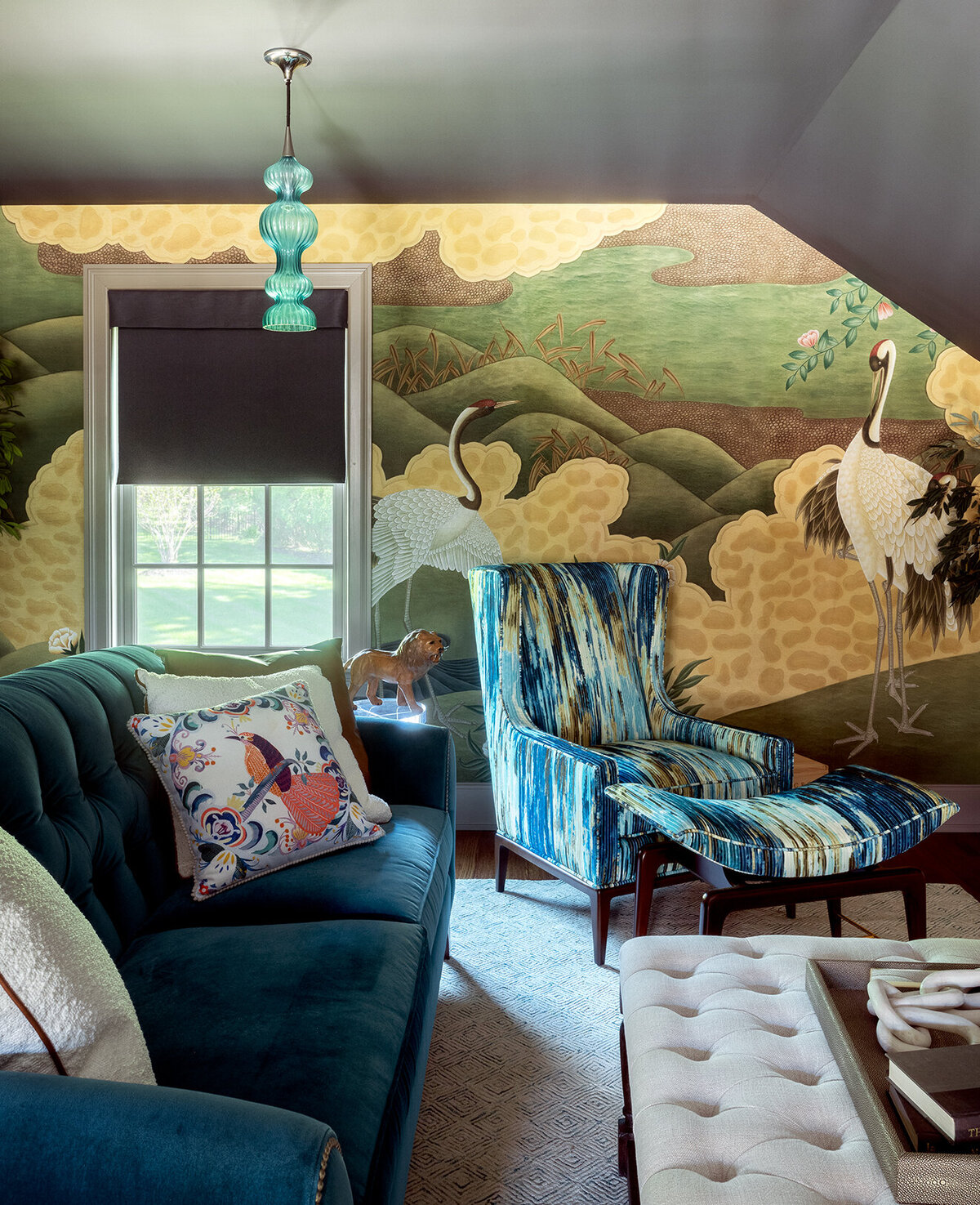 guest room teal and patterned sofa set with geese wallpaper