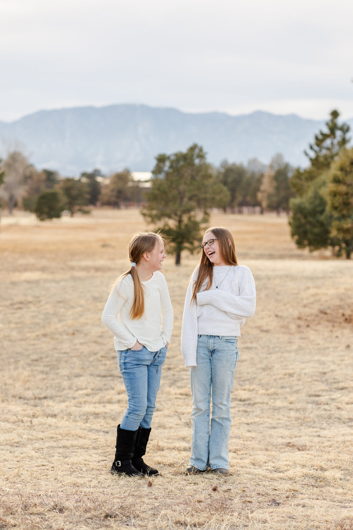Sisters laughing together in a field