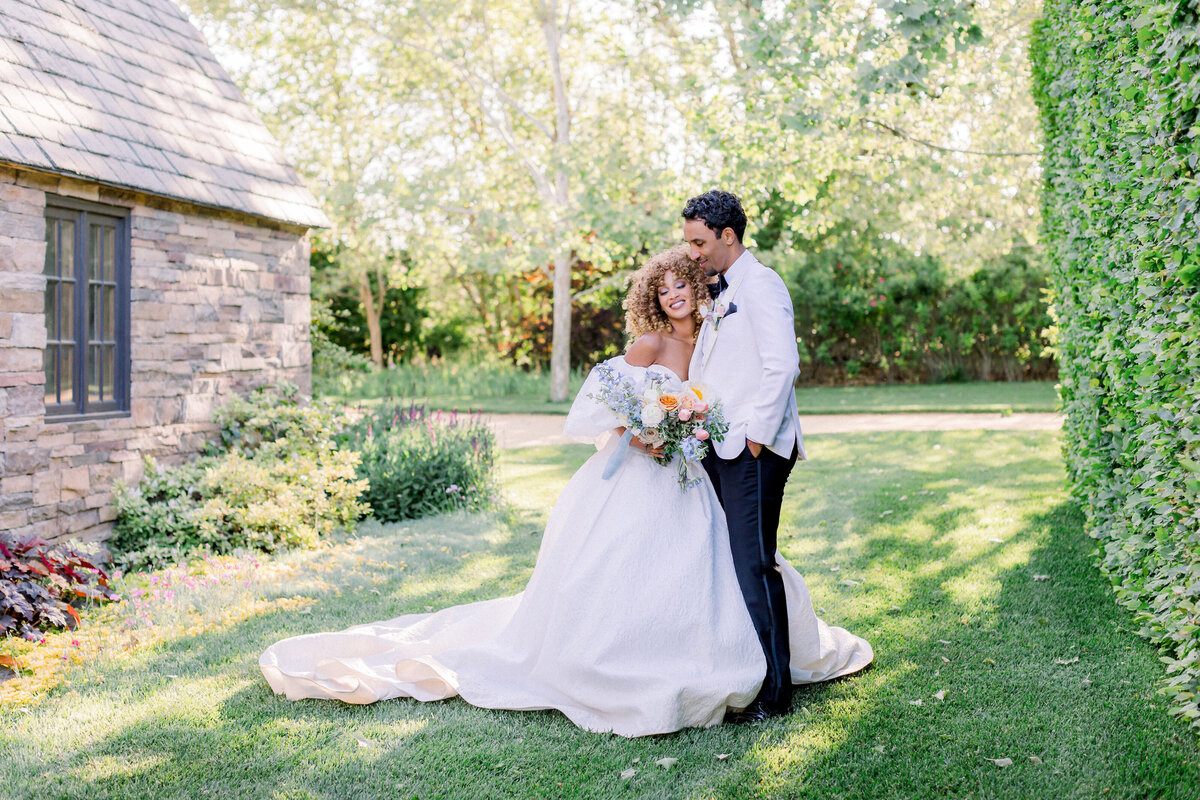 affectionate-couple-portrait-garden-wedding-bouquet-romantic-setting