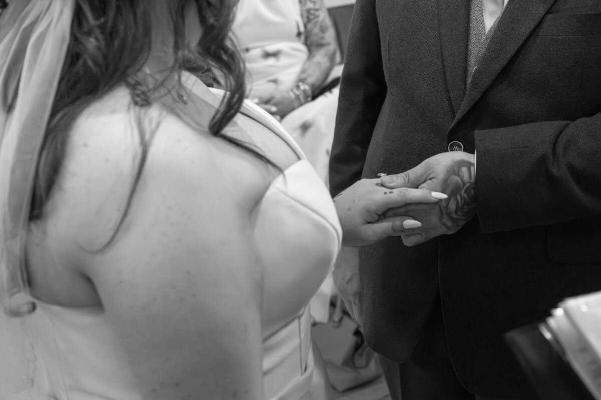 Bride and groom exchanging rings during ceremony in Worsley Court House ceremony room.