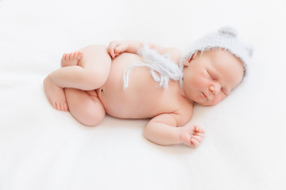 Newborn baby boy wearing a blue bonnet